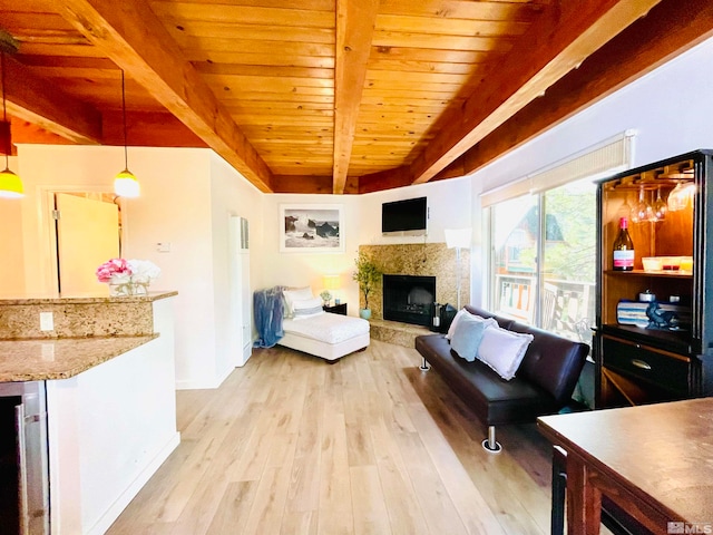 living room with light wood-type flooring, a high end fireplace, beamed ceiling, and wooden ceiling