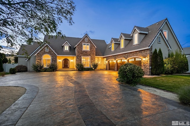 view of front of home featuring a yard and a garage