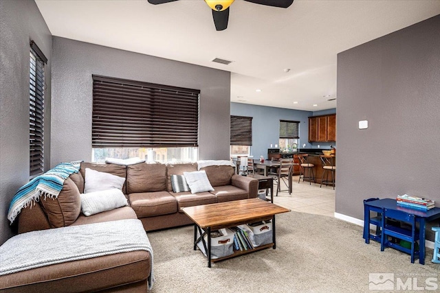 living room featuring ceiling fan and light colored carpet