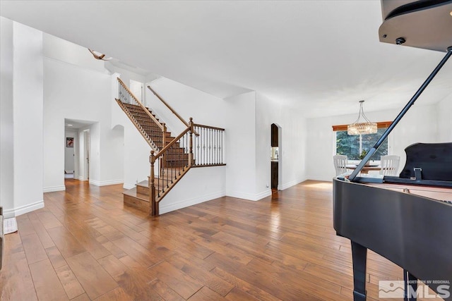 entrance foyer featuring hardwood / wood-style floors and a notable chandelier