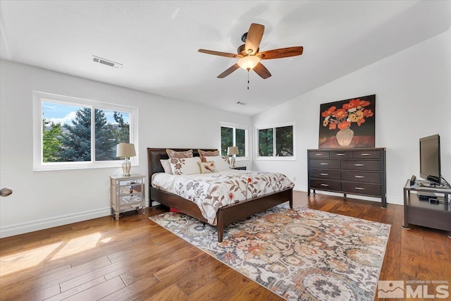 bedroom featuring ceiling fan, wood-type flooring, lofted ceiling, and multiple windows