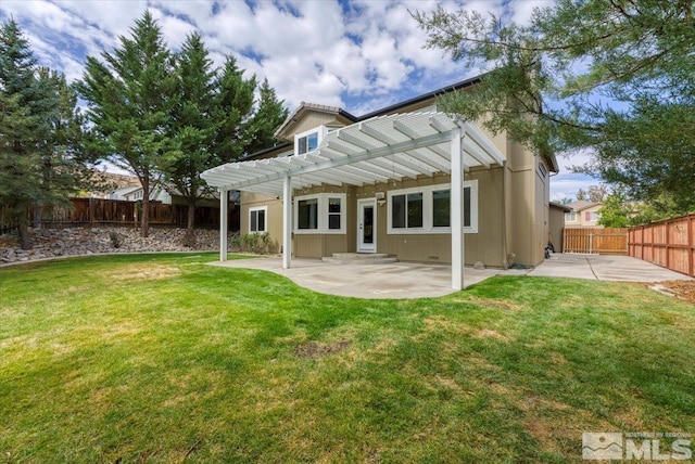 back of house with a lawn, a pergola, and a patio area