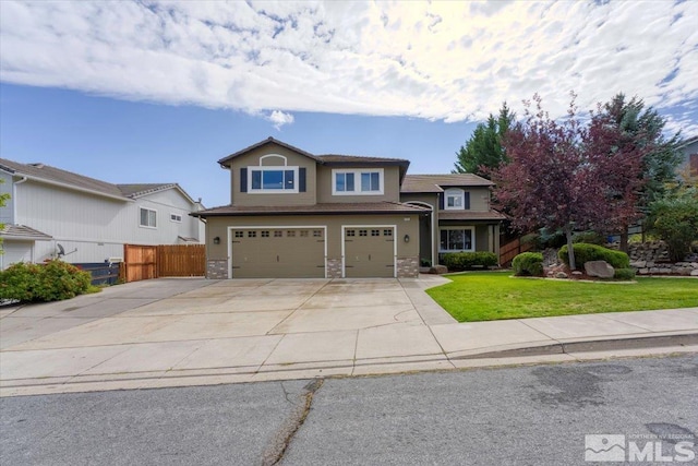 view of front of house with a front yard and a garage