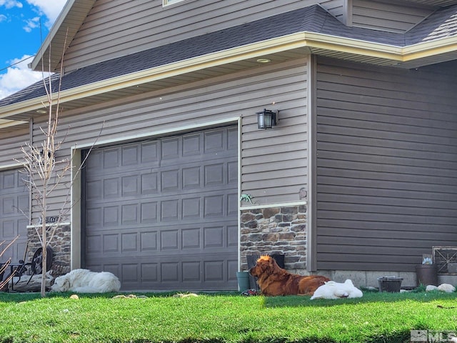 garage featuring wood walls and a yard