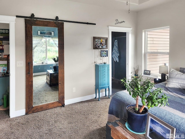 bedroom with carpet flooring and a barn door