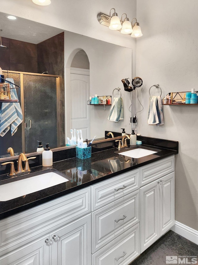 bathroom with an enclosed shower and vanity