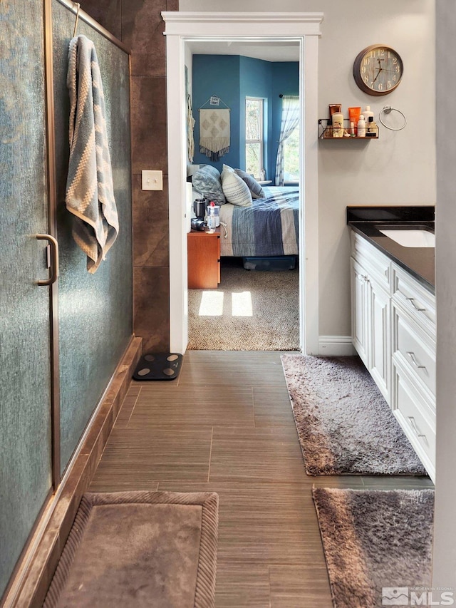 bathroom with an enclosed shower and vanity