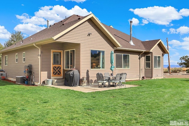 rear view of property featuring a patio area and a yard