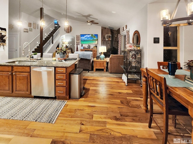 kitchen featuring vaulted ceiling, dishwasher, light wood-type flooring, ceiling fan, and decorative light fixtures