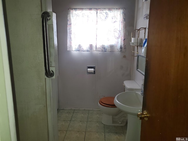 bathroom featuring tile patterned floors and toilet