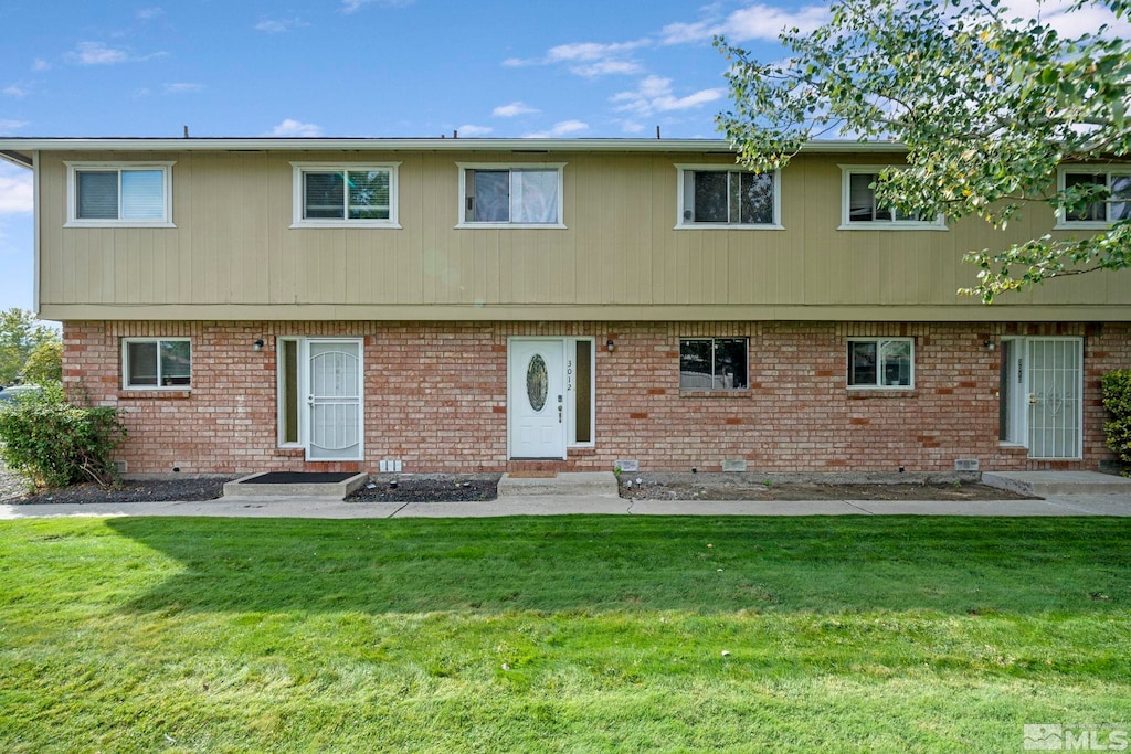 rear view of property with a lawn