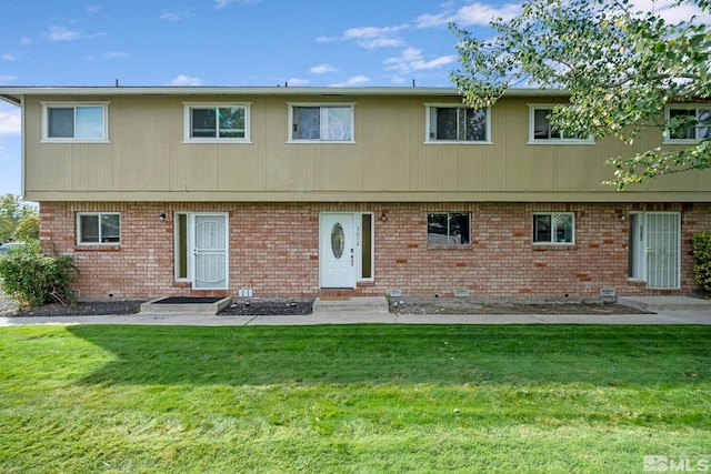 rear view of property with a lawn