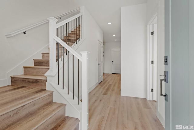 stairway featuring wood-type flooring