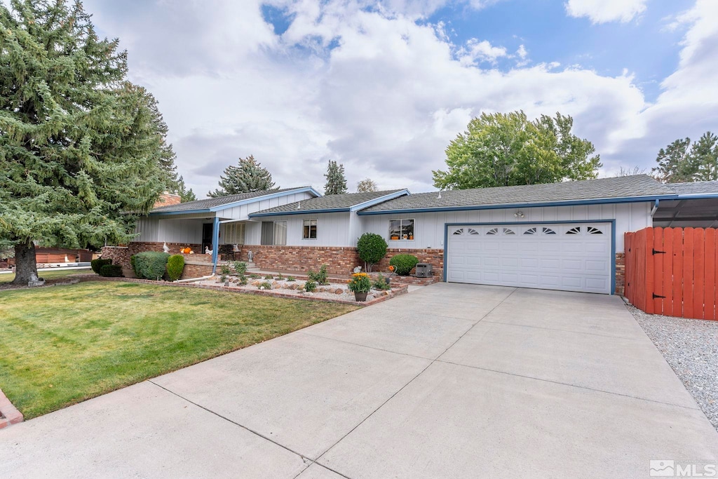 single story home with a garage and a front lawn