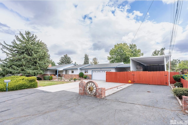 view of front of home featuring a carport and a garage