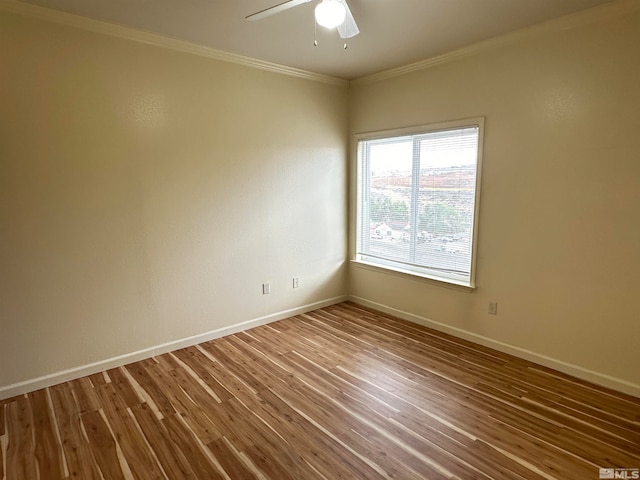 spare room with crown molding, ceiling fan, and wood-type flooring