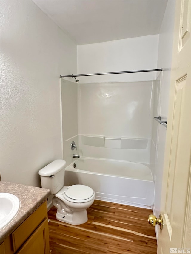 full bathroom with vanity, wood-type flooring, bathtub / shower combination, and toilet