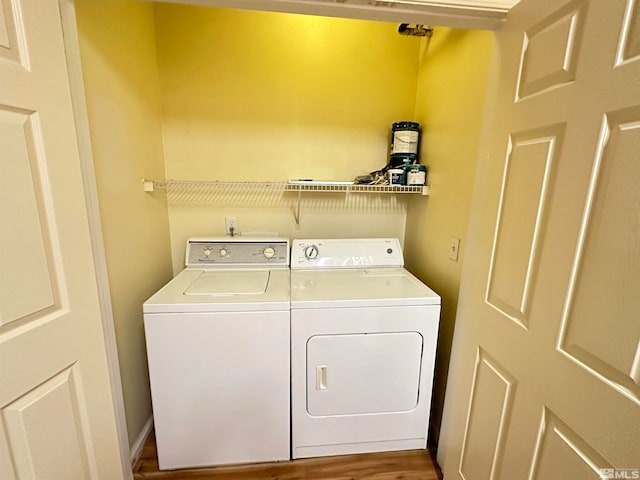 laundry room featuring washer and clothes dryer and hardwood / wood-style floors