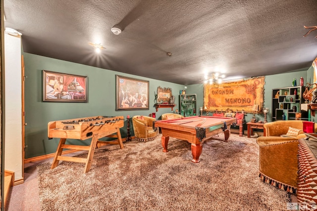 rec room featuring pool table, carpet, and a textured ceiling