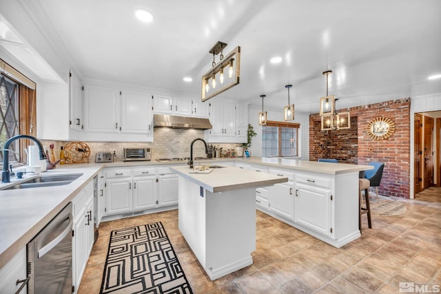 kitchen featuring sink, stainless steel dishwasher, a kitchen island with sink, white cabinetry, and a kitchen breakfast bar