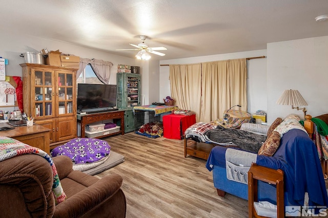 living room with wood-type flooring and ceiling fan