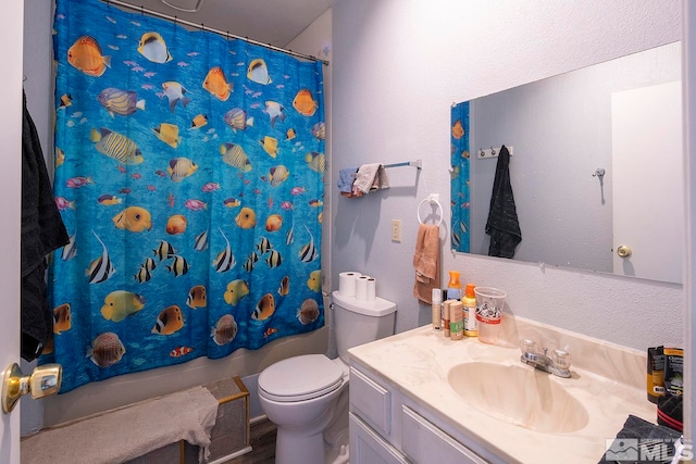 full bathroom featuring shower / bath combo, vanity, and toilet