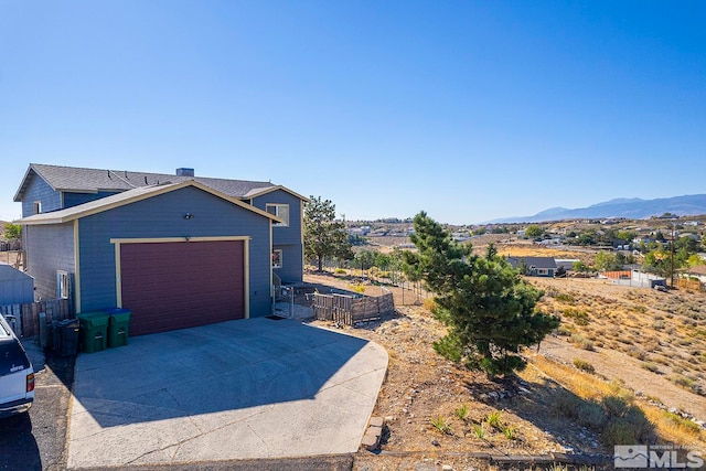 view of front of house featuring a mountain view and a garage