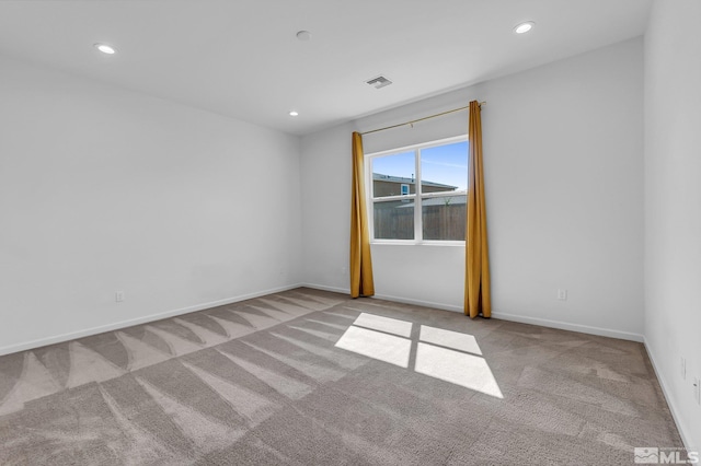 unfurnished room featuring light colored carpet