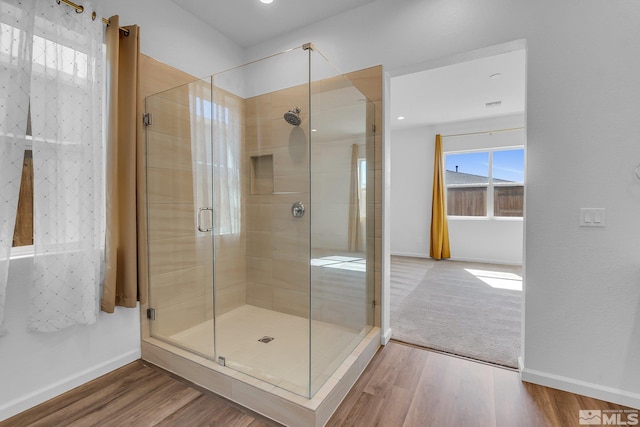 bathroom featuring hardwood / wood-style flooring and an enclosed shower