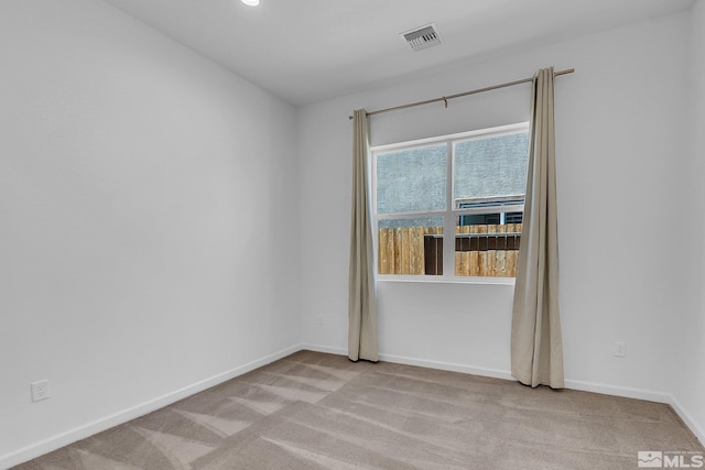 empty room featuring light carpet