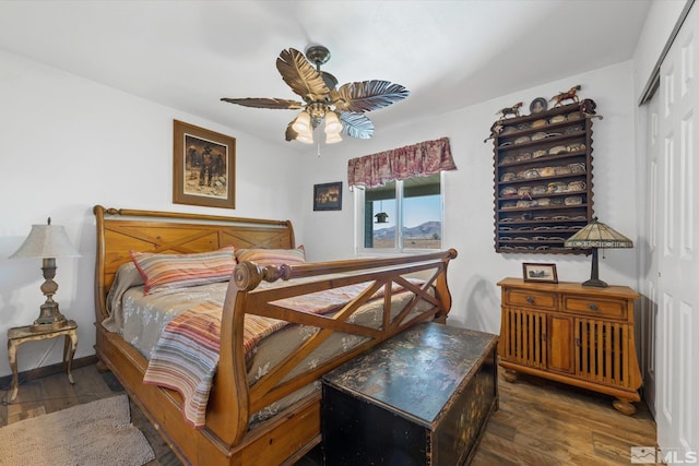 bedroom featuring a closet, ceiling fan, and dark wood-type flooring