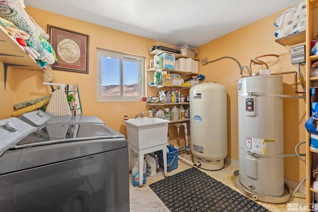 laundry area featuring gas water heater, secured water heater, independent washer and dryer, and light tile patterned flooring