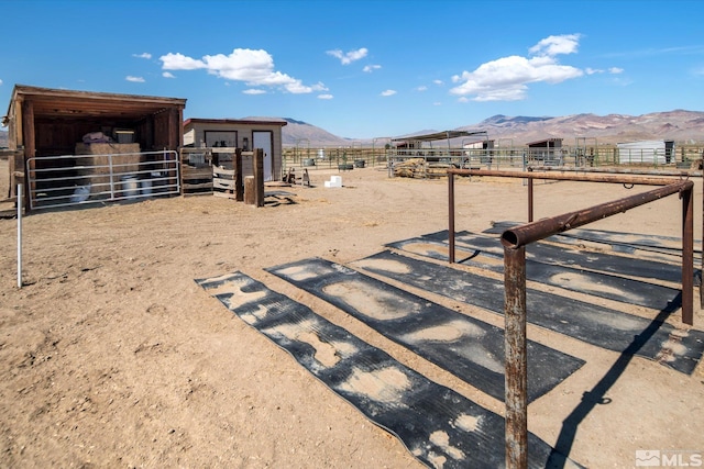 view of yard with a mountain view, an outdoor structure, and a rural view