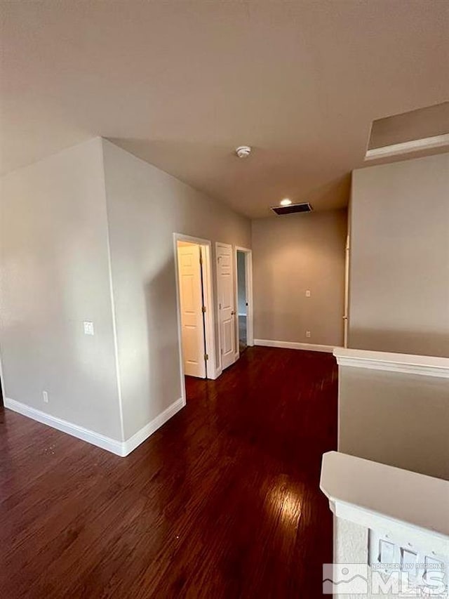 unfurnished room with dark hardwood / wood-style floors