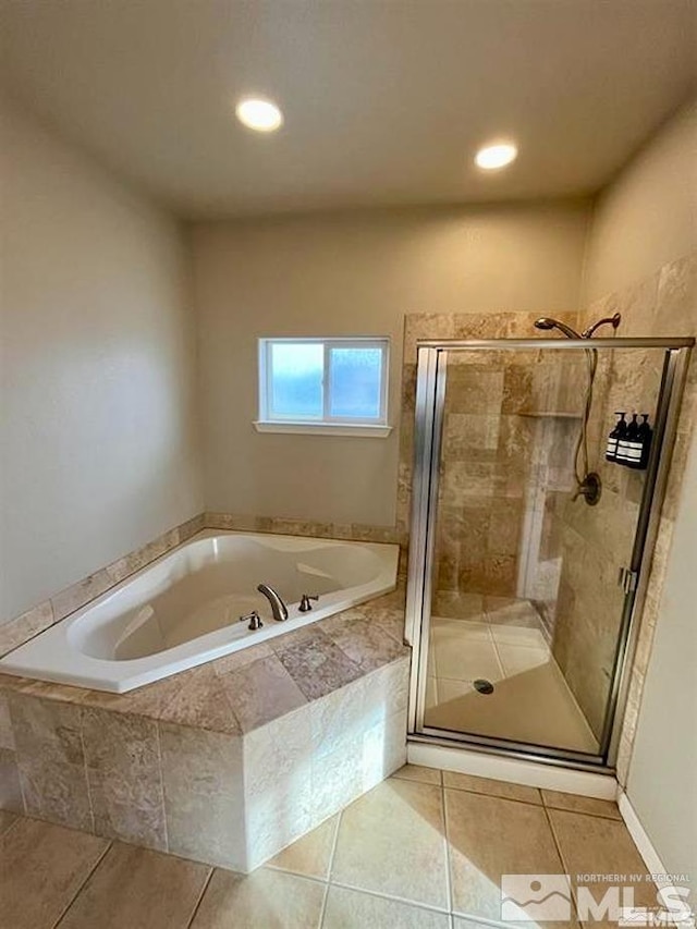 bathroom with tile patterned floors and separate shower and tub