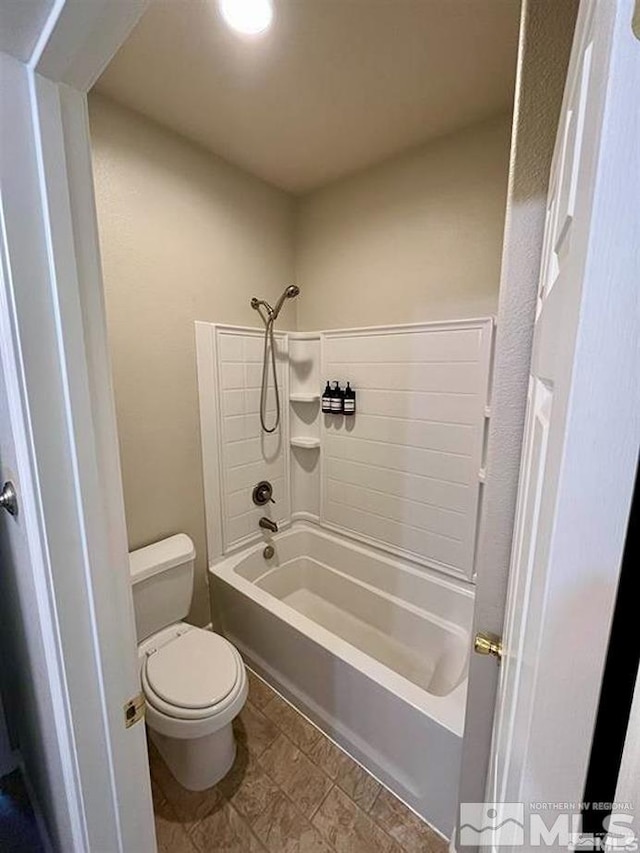 bathroom featuring toilet and shower / washtub combination