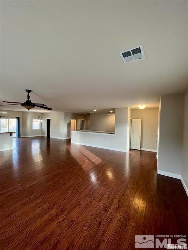 unfurnished living room with dark wood-type flooring