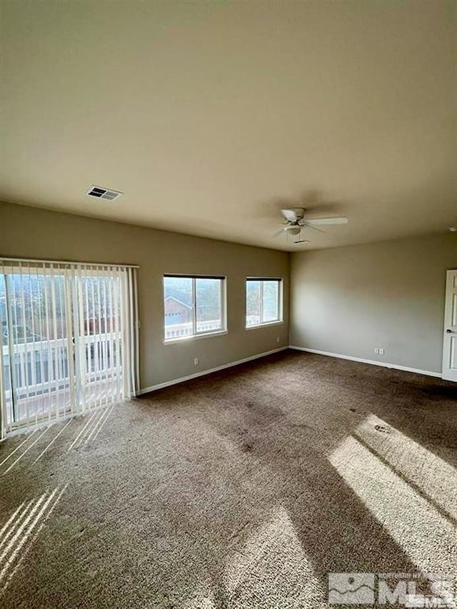 unfurnished room with carpet and ceiling fan