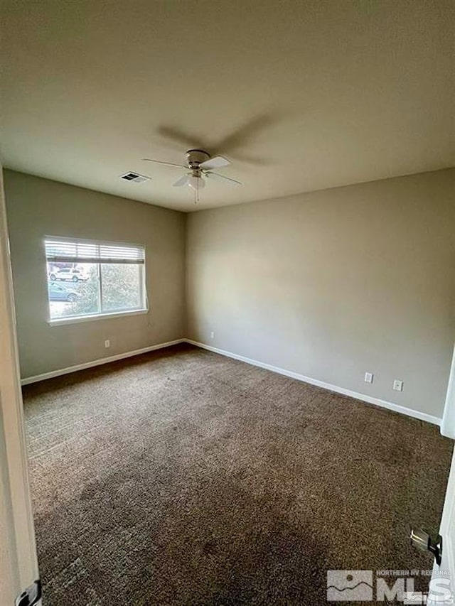 carpeted spare room with ceiling fan