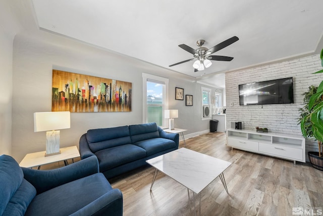 living room with light hardwood / wood-style floors and ceiling fan