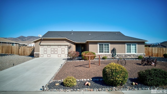 single story home featuring a garage and a mountain view