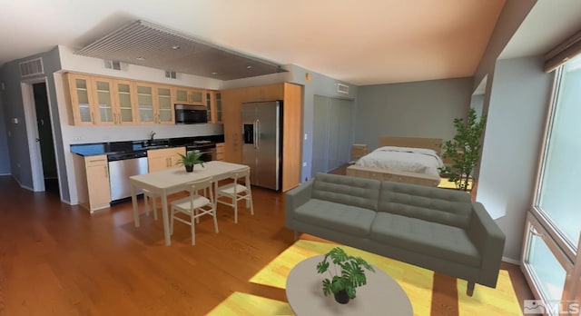 bedroom with light hardwood / wood-style flooring, sink, and stainless steel fridge with ice dispenser