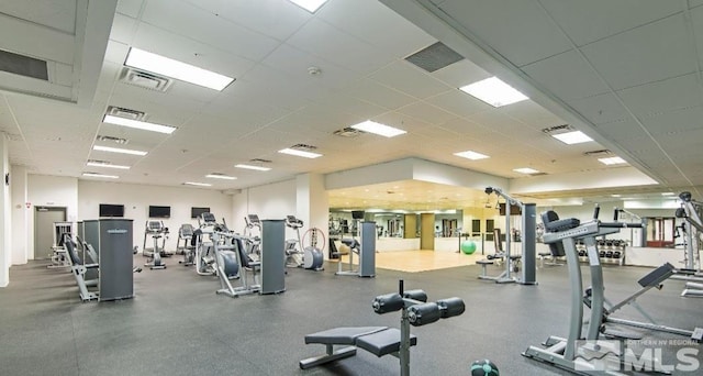 gym with a paneled ceiling