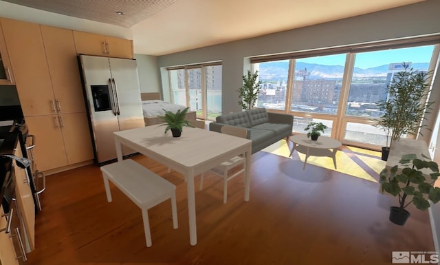 dining room featuring wood finished floors and a mountain view