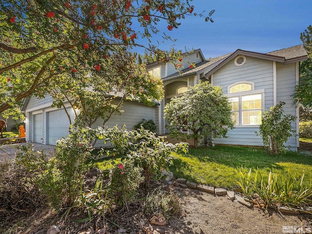 view of front of property featuring a garage and a front lawn