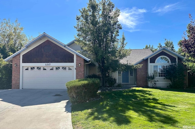 view of front of home with a front yard and a garage