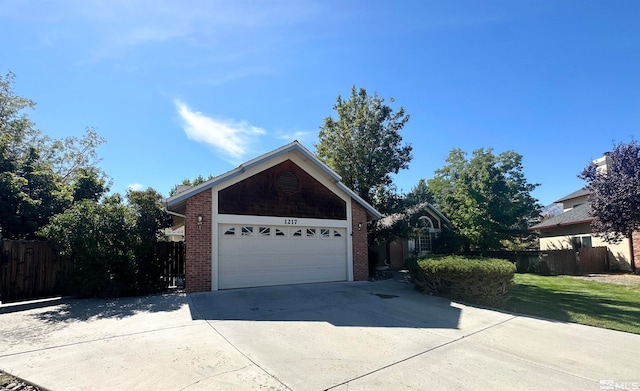 view of front of property featuring a garage and a front lawn