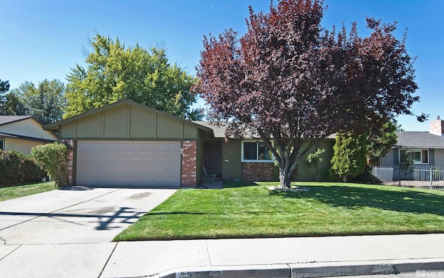 view of front of house featuring a garage and a front lawn