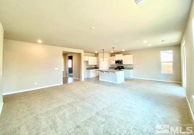 unfurnished living room with light carpet