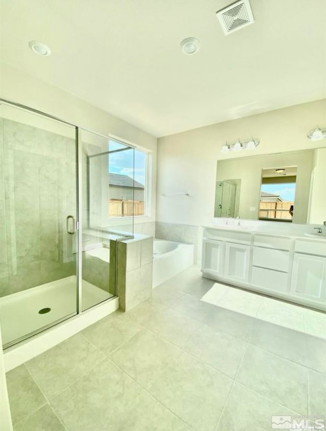 bathroom with tile patterned flooring, plenty of natural light, vanity, and separate shower and tub